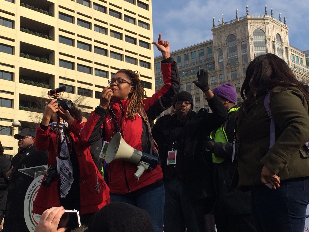 An unidentified woman steals the stage and takes the lead at Al Sharpton's Justice For ALL March at Freedom Plaza.