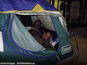 Panama and Byron set up their tent on a sidewalk in Washington, DC.