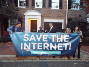 Activists greet FCC Chairman Tom Wheeler early in the morning at his house in Georgetown.