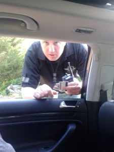Dfc. Christopher Sloane leans into car and asks for I.D. after he stopped two cars in the Cove Point neighborhood.