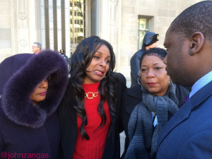 Gina Best (center) and supporters pleading with DOJ press secretary Kevin Lewis/Photo by John Zangas