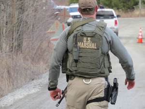 U.S. Marshals wore body armor and carried AR-15 assault weapons./ Photo by Vera Scroggins
