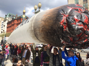 Advocates for federal legalization of marijuana carry a giant inflated joint./Photo by John Zangas