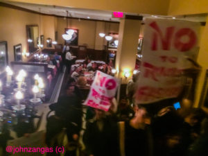 Anti-fascist protesters rush into the dining room where NPI members are eating./Photo by John Zangas